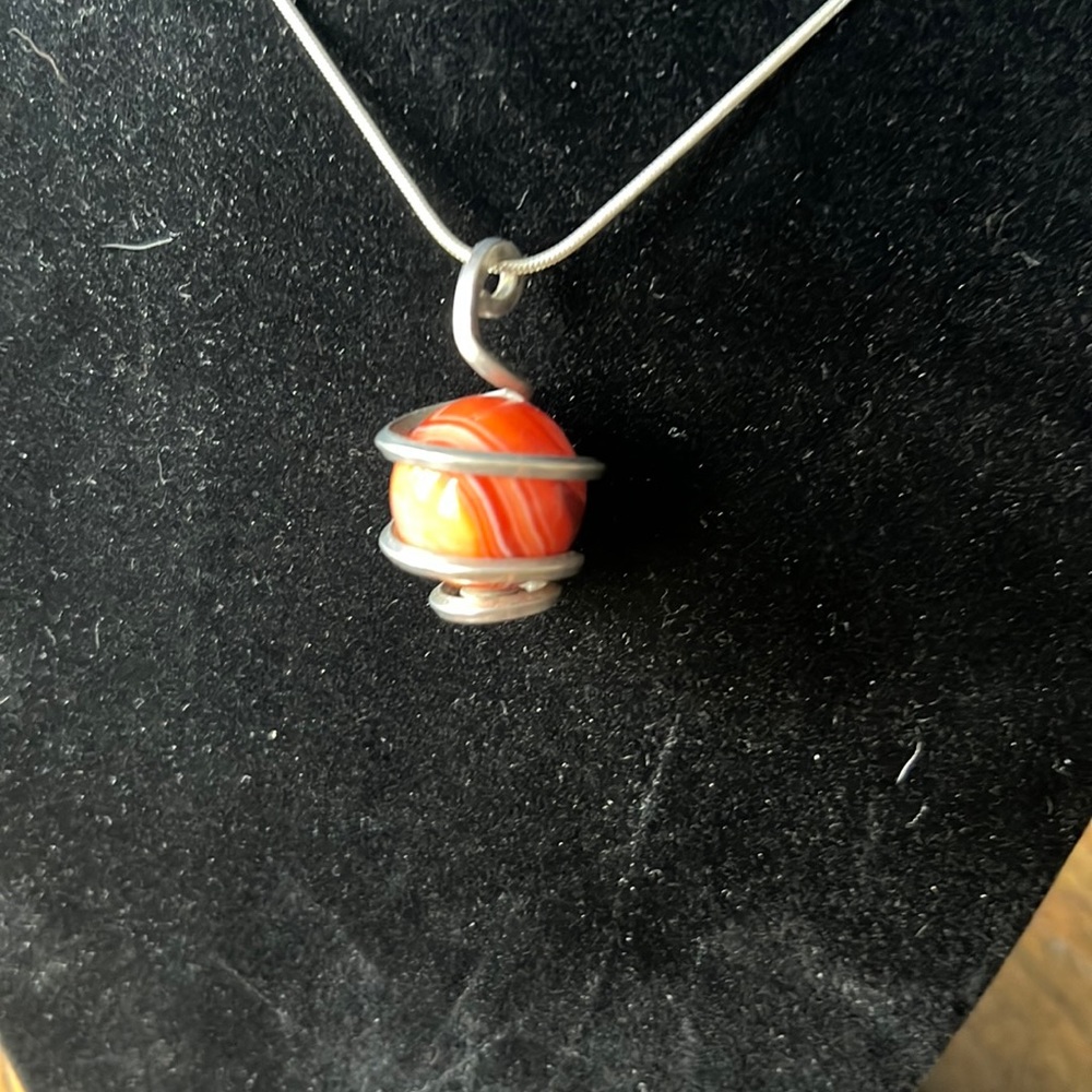 Silver-tone metal pendant with Orange swirl glass ball